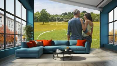 back view of a couple contemplating a landscape while imagining their future home Wall mural