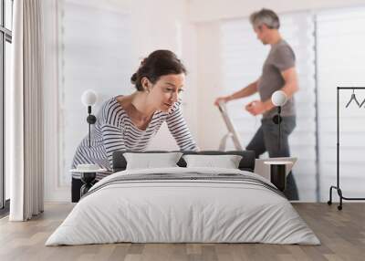 Cheerful couple performing renovation work in a house Wall mural