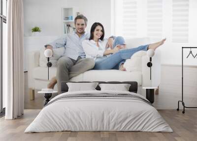 Couple at home relaxing in sofa Wall mural