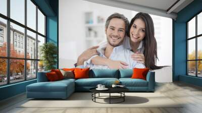 Couple at home relaxing in sofa Wall mural