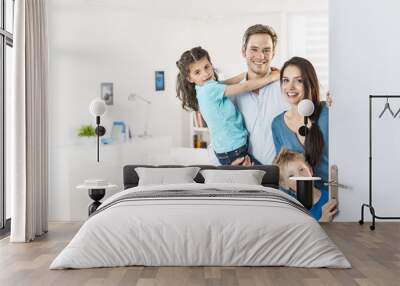 Family standing at front door to invite people at home Wall mural