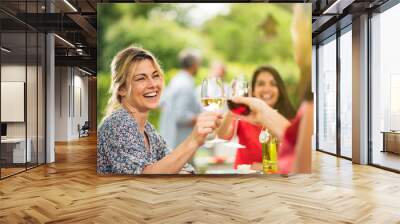 Group of friends doing a bbq, focus on a woman Wall mural