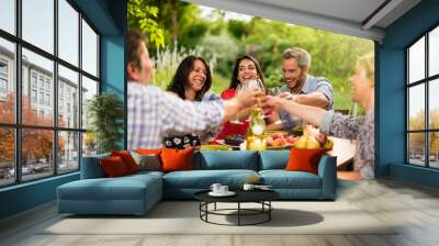 Group of friends toasting during a party on a terrace in summer Wall mural