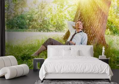 handsome grey hair man taking a break, barefoot in the grass Wall mural