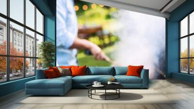 In summer. A couple prepares a bbq to welcome friends in the garden. Close-up on a plate of grill skewers Wall mural