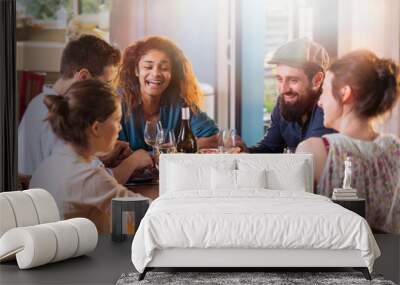 Mixed group of friends having fun while sharing a meal  Wall mural