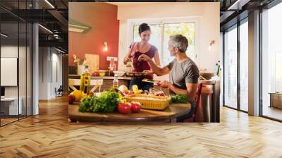 nice couple cooking together vegetables in retro red kitchen Wall mural