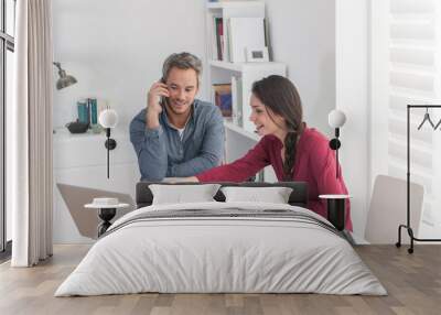 portrait of a couple of architects working on ideas, sitting at Wall mural