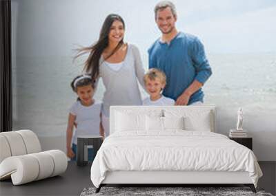 portrait of a happy family standing on the beach Wall mural