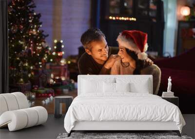 portrait of a young couple in their living room at christmas eve Wall mural