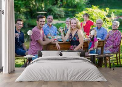 Summertime, cheerful family gathered for picnic in the garden Wall mural