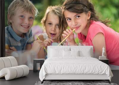 Three Children having a snack in the garden Wall mural