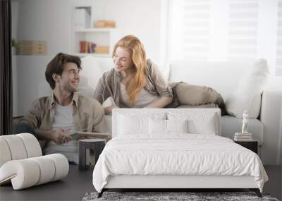 young couple sharing music on tablet Wall mural