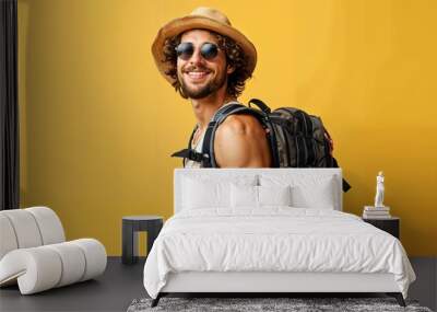 Happy young male wearing sunglasses and hat with black backpack isolated on pastel background, handsome Wear a tank top travel concept Wall mural