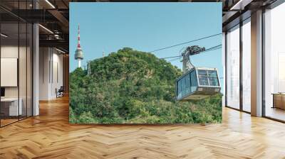 Green forest on a mountain and cable car view of Namsan Seoul tower park in Seoul South Korea Wall mural