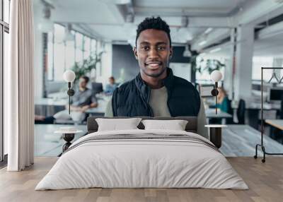 African male designer standing in modern office Wall mural