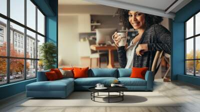 african woman taking coffee break while working from home Wall mural