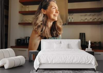 Aging woman smiling happily while holding a buddha bowl Wall mural