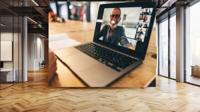 Anonymous businesswoman attending a virtual meeting in a modern office Wall mural