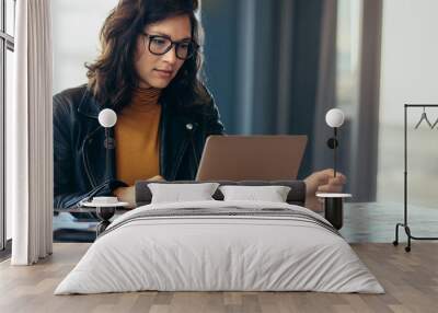 Asian woman working laptop at office Wall mural