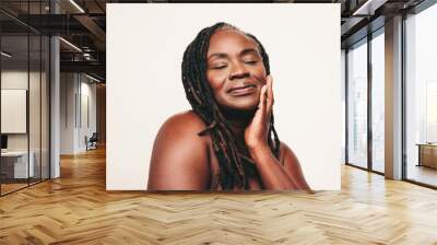 Beautiful black woman touching her flawless skin Wall mural