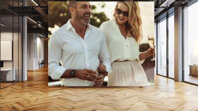 Beautiful couple with a glass of wine outdoors Wall mural