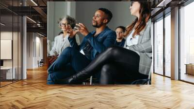 Black business man speaking at a workshop with colleagues in a conference setting Wall mural