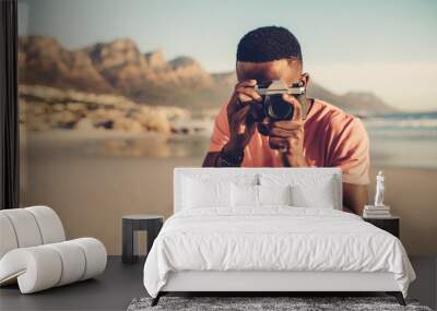 Black guy using digital camera on beach Wall mural