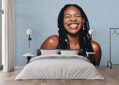 Black woman smiling in a studio Wall mural