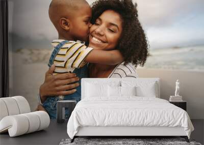 Boy enjoying at day out with his mother on the beach Wall mural