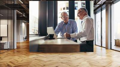 Business men working together in modern cafe Wall mural