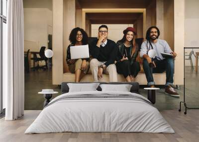 Business partners sitting together in office in an enclosure Wall mural