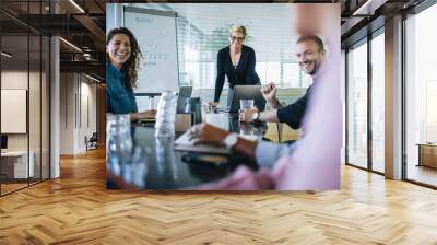 Business team smiling during a meeting Wall mural