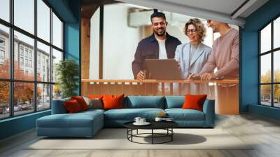 Business woman showing her colleagues a presentation on a laptop Wall mural