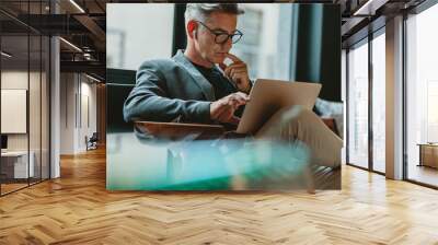 Businessman reading emails in office lobby Wall mural