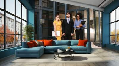 Businessman with female colleagues in corporate office building Wall mural