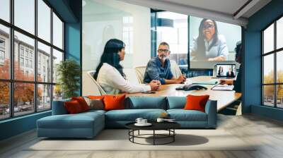 Businesspeople having a virtual meeting with their partners in a boardroom Wall mural