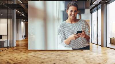 Businesswoman in office using a cell phone Wall mural