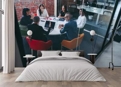 Businesswoman leading a meeting in a modern workplace Wall mural