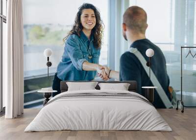 Businesswoman shaking hands with a job applicant Wall mural