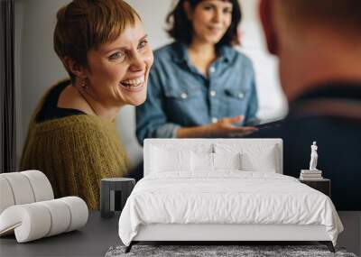 Businesswoman smiling during a meeting in office Wall mural