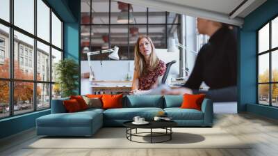 Businesswoman speaking with her colleague in office Wall mural