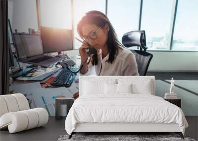 Businesswoman working at her desk in office. Wall mural