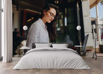 Businesswoman working from a coffee shop Wall mural