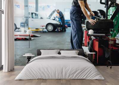 Car repair shop with mechanics working Wall mural