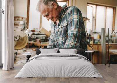 Carpenter preparing drawing for furniture parts Wall mural