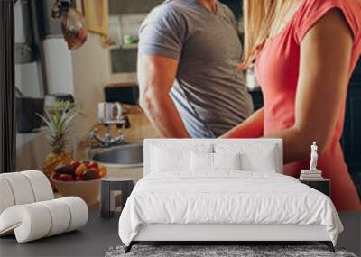 Caucasian couple in the kitchen preparing breakfast Wall mural