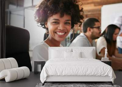 Cheerful african woman in conference room with coworkers Wall mural