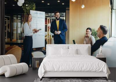 Cheerful businesspeople having a discussion as a team Wall mural