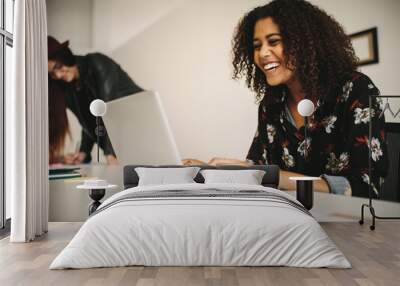 Cheerful businesswoman at work in office Wall mural